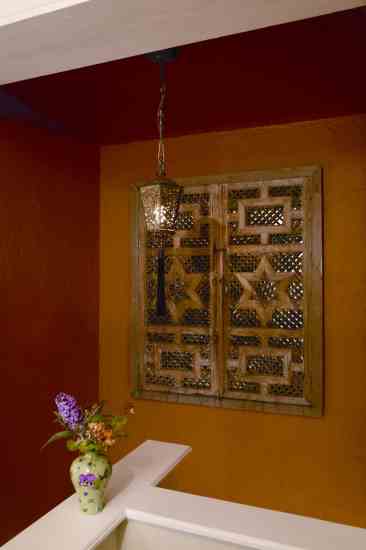 The stairwell between the original and new lower levels became a blank canvas for Alma to display this carved Moroccan panel and lantern; the antique shop owner said the lantern was from Rudolph Valentino’s estate.